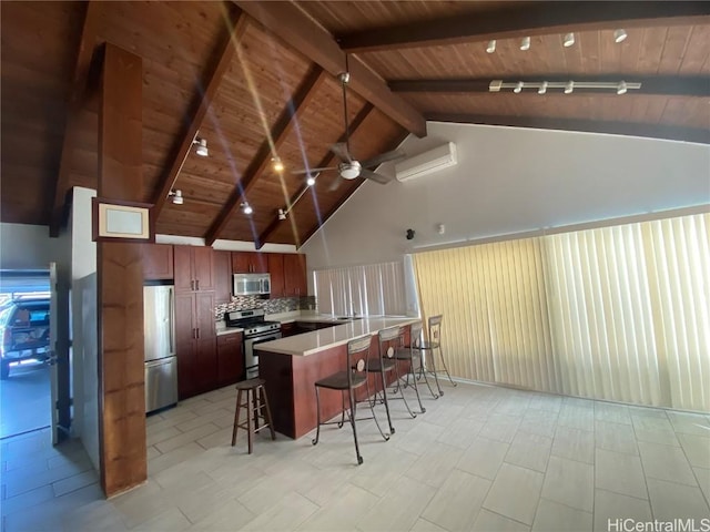 kitchen with a wall mounted AC, beam ceiling, tasteful backsplash, appliances with stainless steel finishes, and a breakfast bar area