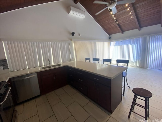 kitchen with an AC wall unit, kitchen peninsula, black oven, stainless steel dishwasher, and a kitchen bar