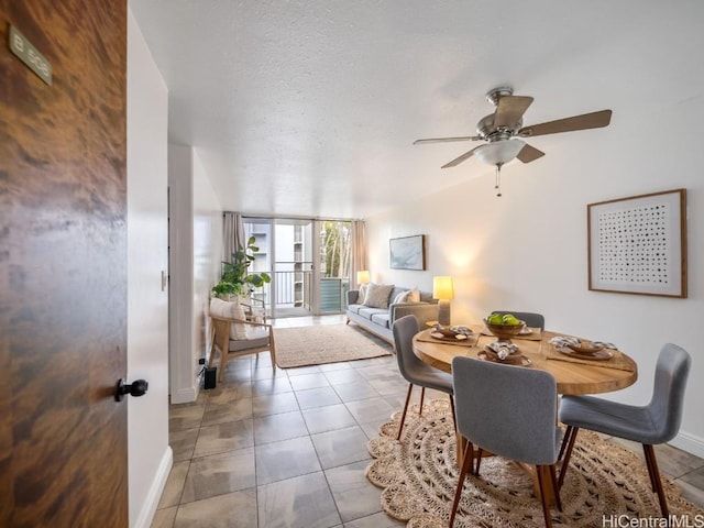 tiled dining area featuring ceiling fan and a textured ceiling