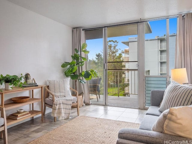living area with light tile patterned floors and expansive windows