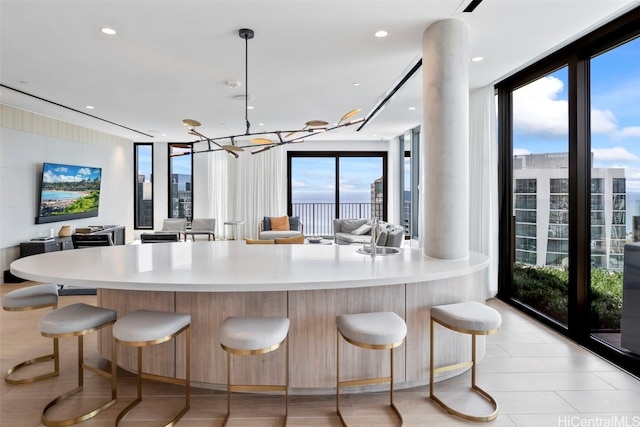 kitchen with open floor plan, light countertops, and a breakfast bar