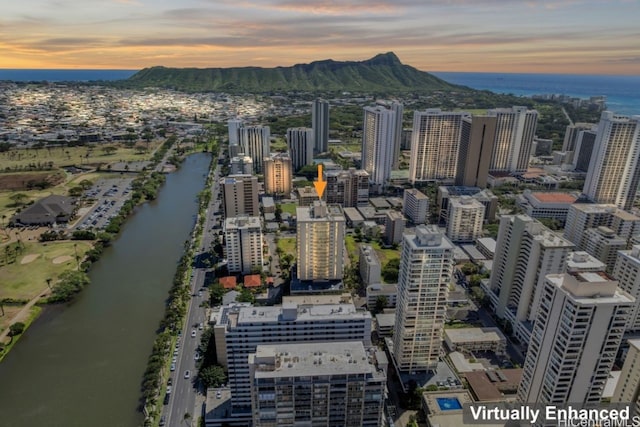 aerial view at dusk with a water view and a view of city