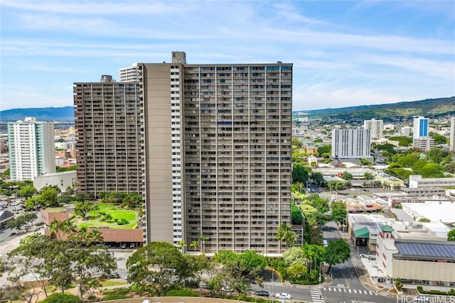 view of building exterior with a mountain view and a city view