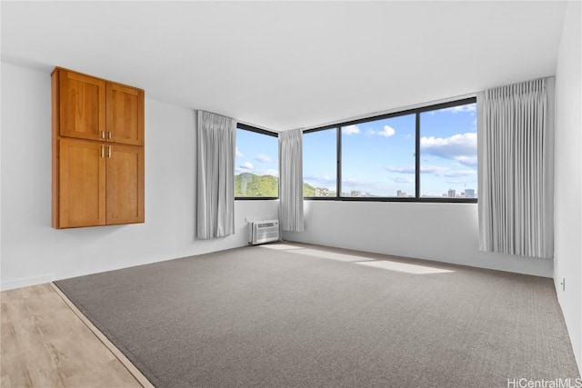 unfurnished room featuring a wall mounted air conditioner