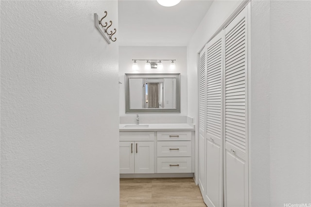 55 S Kukui St Unit D2614, Honolulu, HI 96813 - bathroom featuring a closet, vanity, and wood finished floors
