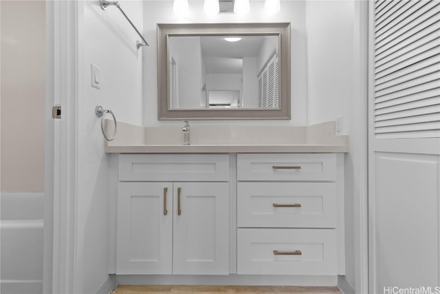 bathroom featuring a closet, visible vents, and vanity