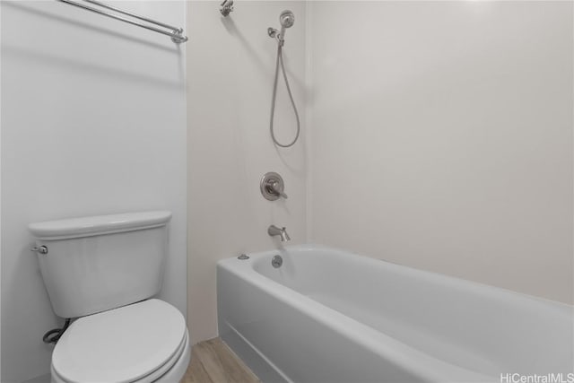 bathroom featuring bathtub / shower combination, wood finished floors, and toilet