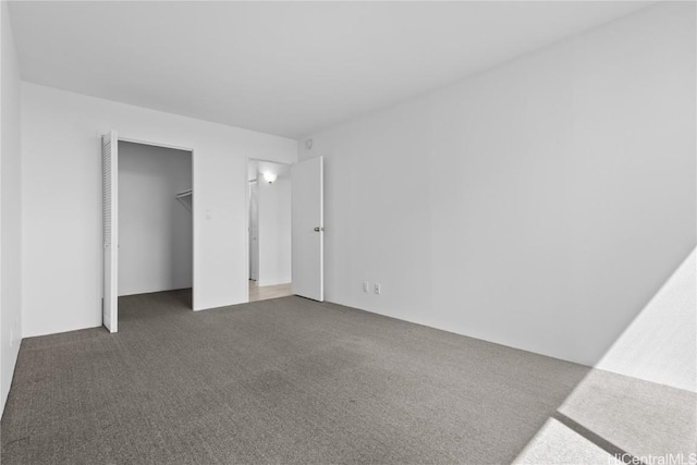 unfurnished bedroom featuring dark carpet