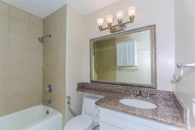 full bathroom with tiled shower / bath combo, toilet, and vanity