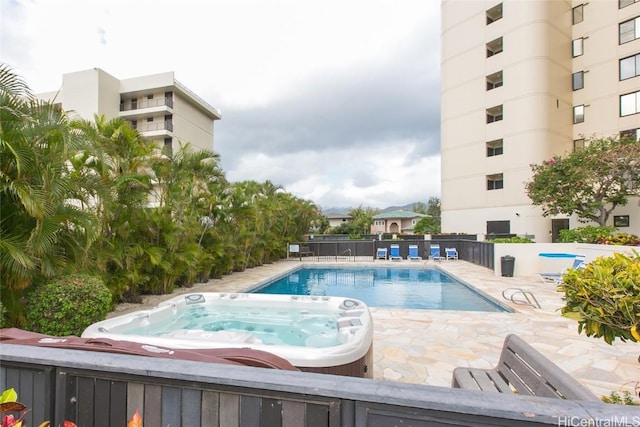 view of swimming pool with an outdoor hot tub and a patio area