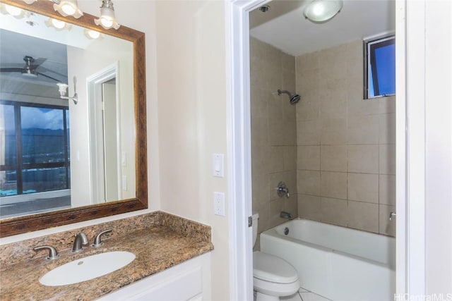 full bathroom with tiled shower / bath combo, vanity, and toilet