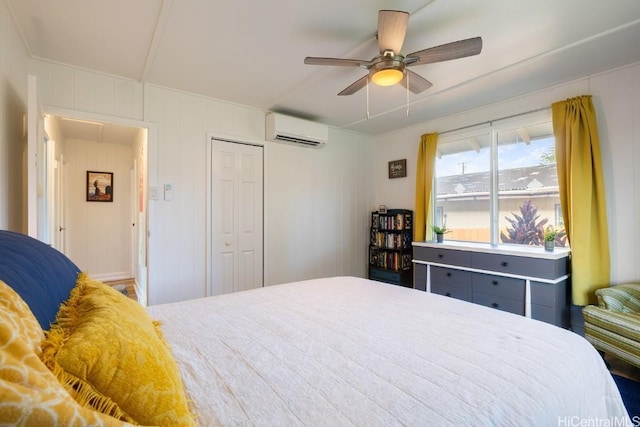 bedroom with a ceiling fan, a closet, and a wall mounted air conditioner