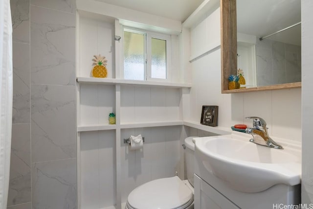 bathroom featuring toilet and vanity