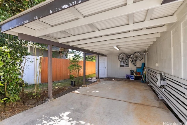 view of patio / terrace featuring fence and an attached carport