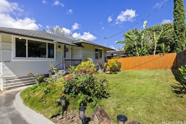 ranch-style house with fence and a front yard