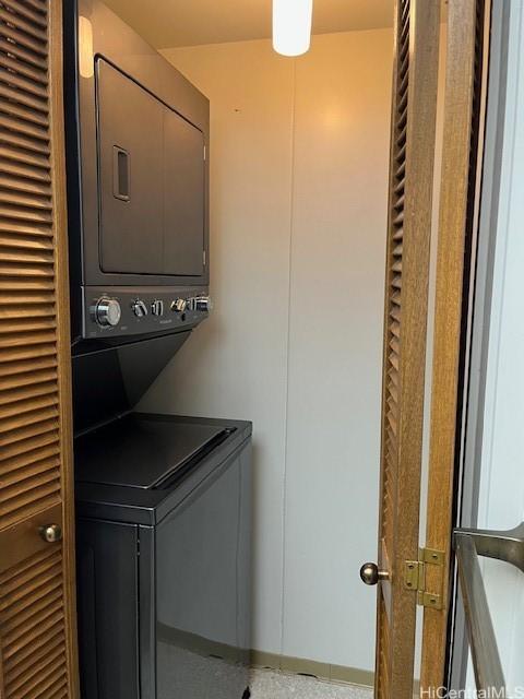 laundry room with stacked washer and clothes dryer and laundry area