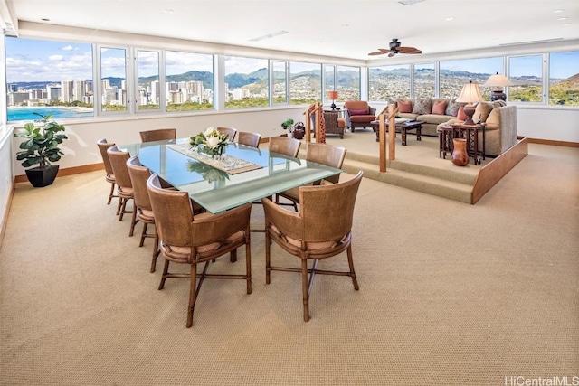 sunroom / solarium with a mountain view and ceiling fan