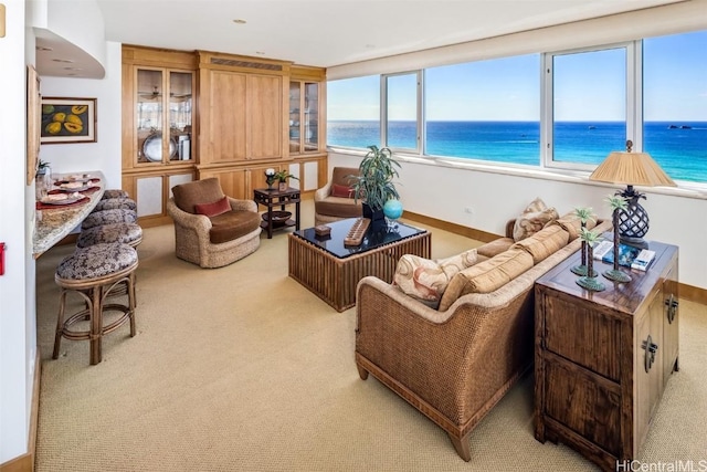 living room featuring a water view and light colored carpet