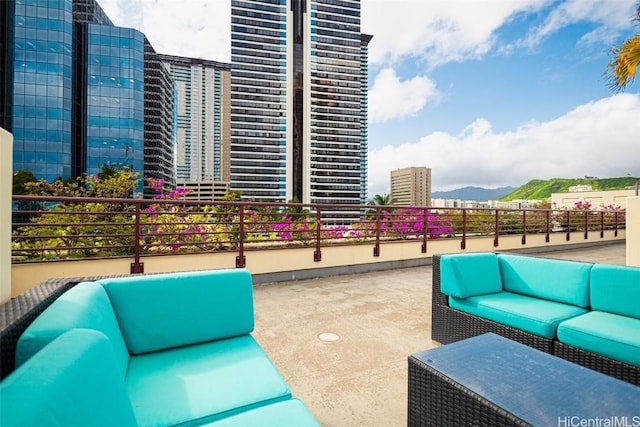 view of patio / terrace with outdoor lounge area, a view of city, and a mountain view