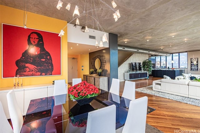 dining space with visible vents and wood finished floors