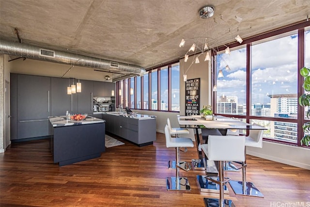 dining area with visible vents, a view of city, baseboards, and dark wood-style floors