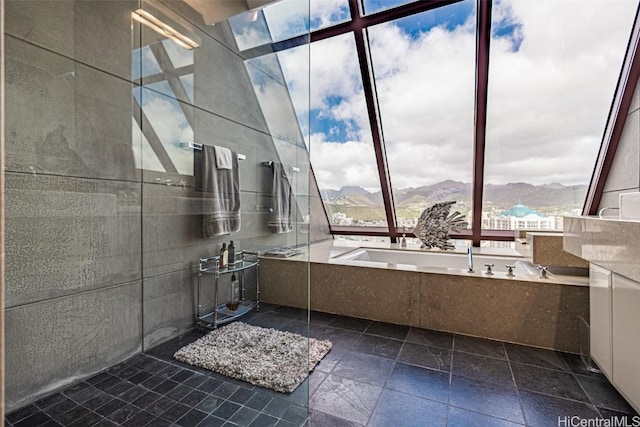 bathroom with a mountain view, a garden tub, vanity, and a walk in shower