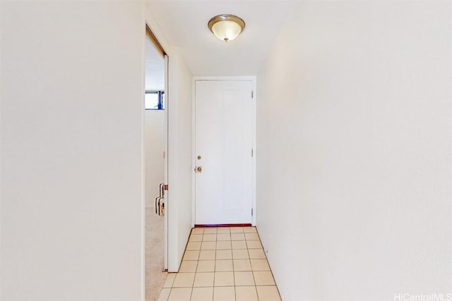 doorway to outside with light tile patterned flooring