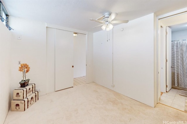 unfurnished room featuring carpet floors and a ceiling fan