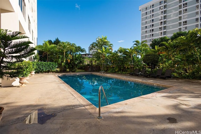 outdoor pool with a patio area