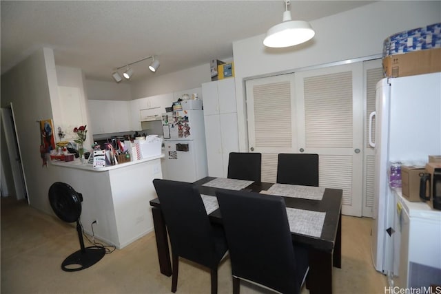 dining room featuring track lighting