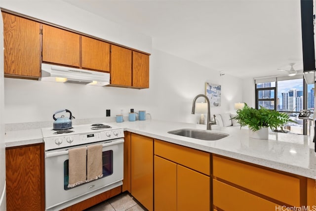 kitchen with light tile patterned floors, sink, light stone counters, white electric range oven, and ceiling fan