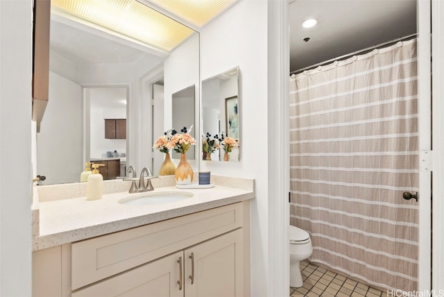 bathroom with vanity, toilet, and tile patterned floors