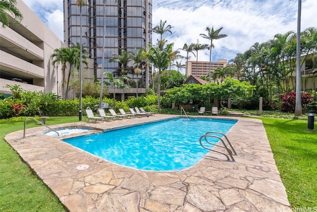 view of swimming pool featuring a patio and a yard