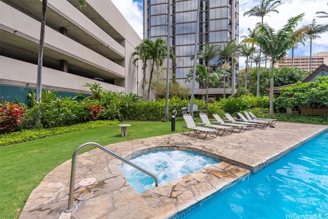 view of pool with a lawn, a community hot tub, and a patio area