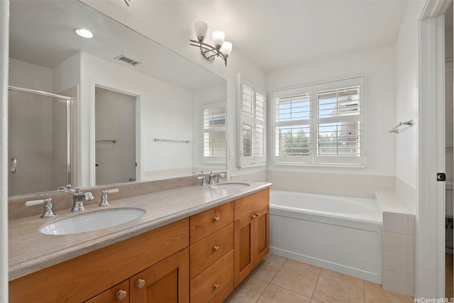full bath with visible vents, a shower stall, tile patterned flooring, and a sink