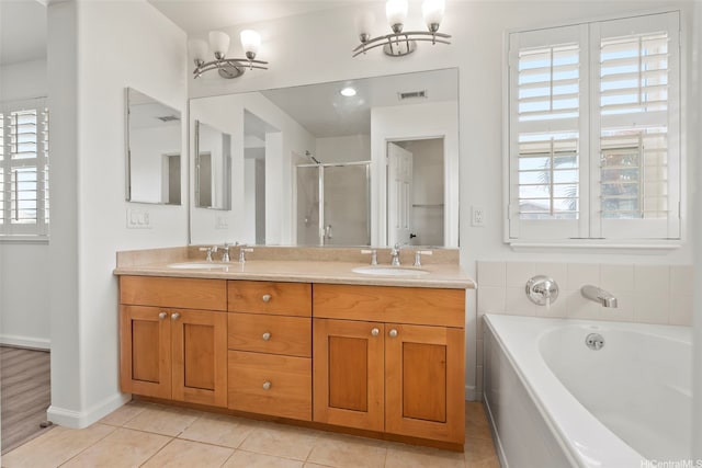 full bathroom featuring a stall shower, a sink, a chandelier, and visible vents