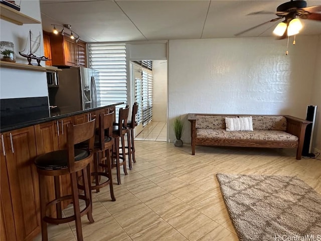 kitchen featuring ceiling fan and stainless steel fridge