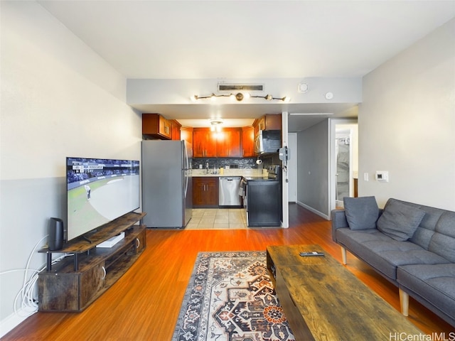 living room with sink and light hardwood / wood-style flooring