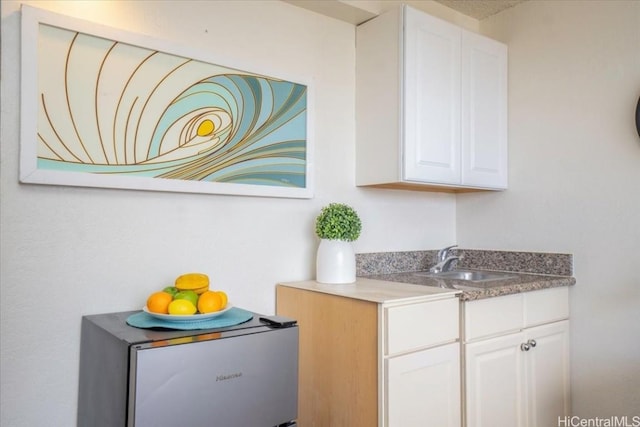 interior space featuring white cabinets and a sink