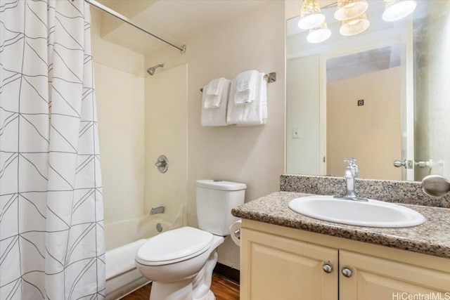 bathroom featuring toilet, shower / bathtub combination with curtain, wood finished floors, and vanity