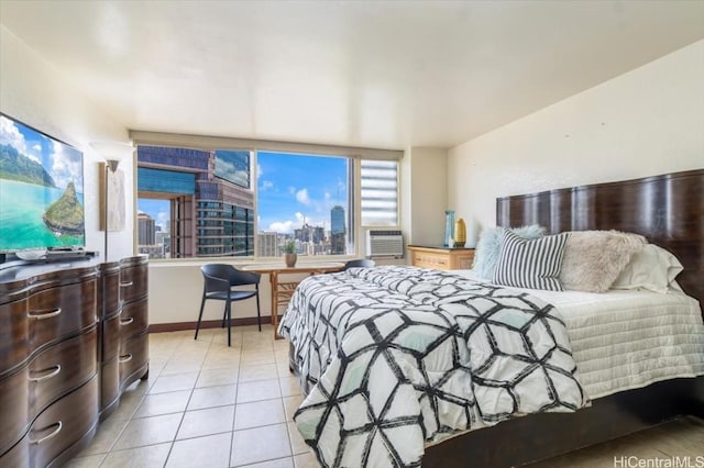 bedroom featuring baseboards, cooling unit, light tile patterned floors, and a city view