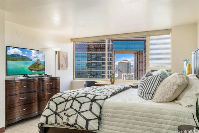 bedroom featuring a city view and light tile patterned flooring