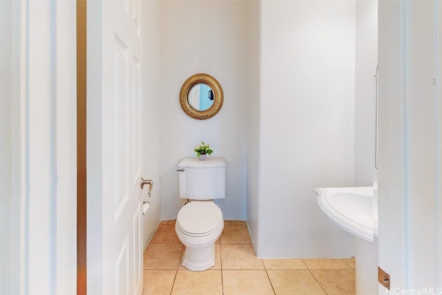 bathroom with toilet and tile patterned floors