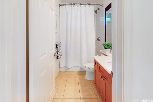 bathroom featuring toilet, shower / tub combo, vanity, and tile patterned floors