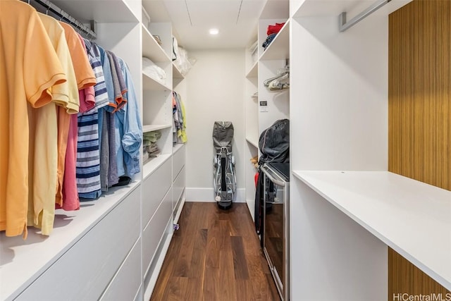 walk in closet featuring attic access and dark wood-style flooring