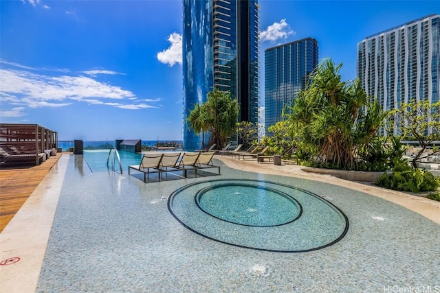 view of pool featuring a view of city