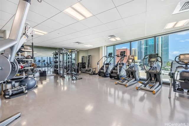 workout area with expansive windows, visible vents, and a wealth of natural light