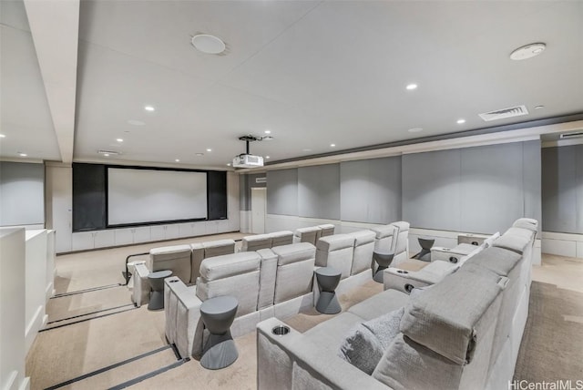 carpeted home theater featuring visible vents, a decorative wall, and recessed lighting