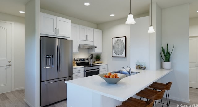 kitchen featuring white cabinetry, kitchen peninsula, stainless steel appliances, a kitchen bar, and pendant lighting