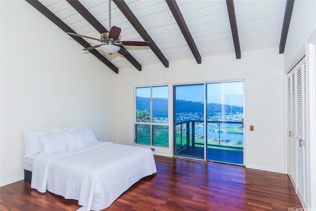 bedroom featuring wood finished floors, lofted ceiling with beams, and access to outside
